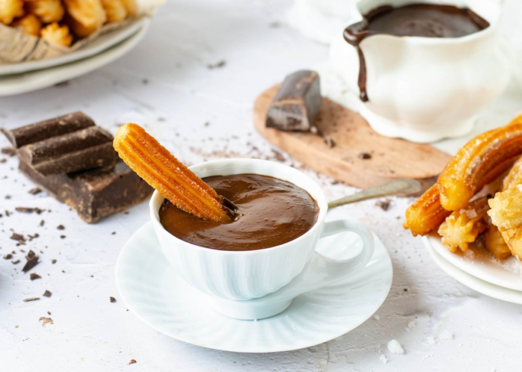 A popular Spanish dessert or snack, churros con chocolate is the perfect sweet indulgence. Churros are long, deep-fried dough pastries that are crispy on the outside and soft inside. They are served with a thick, rich hot chocolate that’s perfect for dipping. While they are often eaten for breakfast, churros are equally loved as an afternoon or late-night treat.