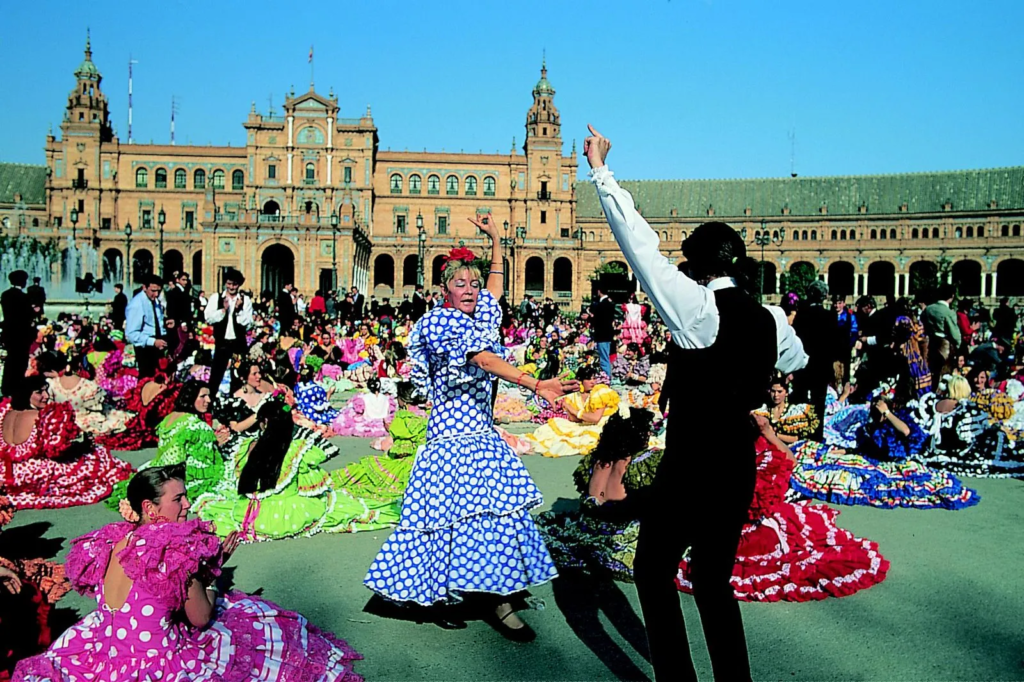 The Feria de Abril, or April Fair, is a week-long celebration in Seville filled with traditional Andalusian music, dancing, food, and drink. It typically takes place two weeks after Easter