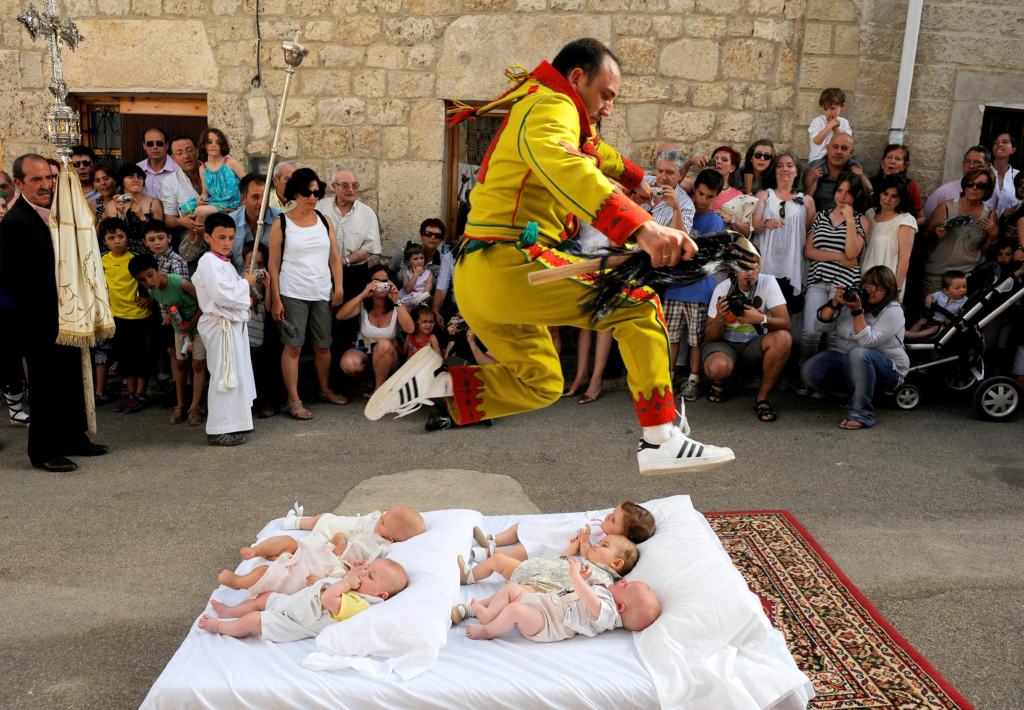 El Colacho, or the "baby jumping festival," is one of the more unusual festivals in Spain. Held annually in the village of Castrillo de Murcia in June, this event involves men dressed as devils jumping over rows of babies lying on mattresses. The ritual is believed to cleanse the babies of original sin and bring them protection for life.